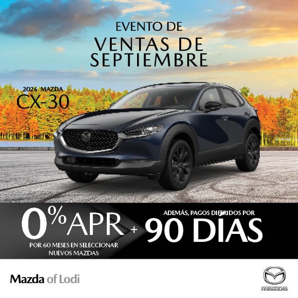 Dark blue Mazda CX-30 SUV against autumn trees